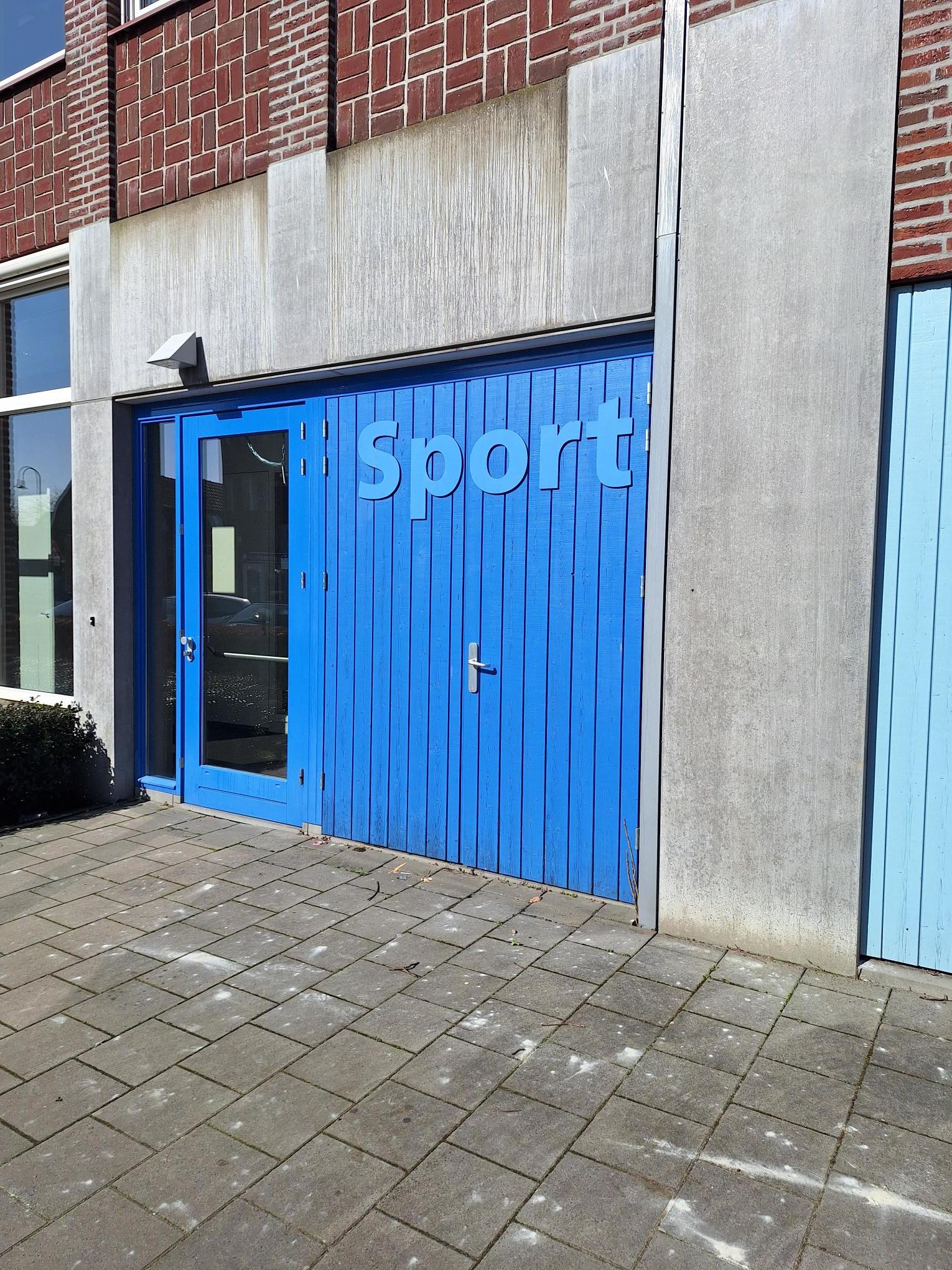 voorkant van stenen gebouw met blauwe deuren